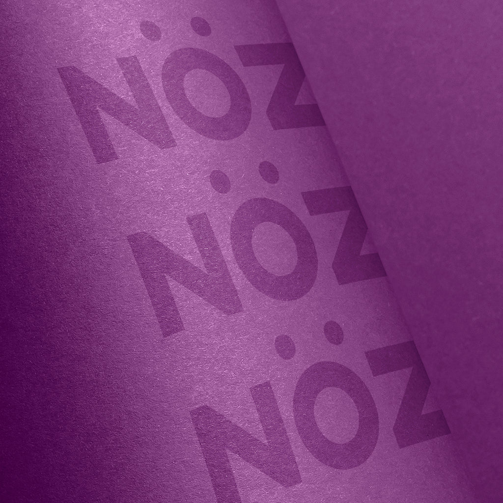 Close up view of Nöz sunscreen stick in purple