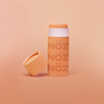 Load image into Gallery viewer, Full view of Nöz sunscreen stick in orange 
